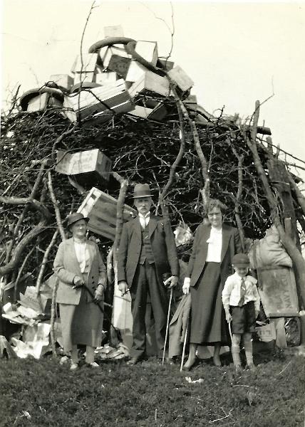 Beacon Copy Bonfire - May 1937.jpg -  Long Preston Beacon Copy Bonfire on 12th May 1937 This photo is of the village bonfire which was built on “Beacon Copy”  and set alight during the Coronation celebrations on May 12 1937.   Left to right are:    Williamina, James, Betty and Geoffrey Parkington. Williamina (1868-1949) and James (1870-1945) were Geoffrey’s grandparents, who lived on The Concrete until they died.  Betty (1901-1960) was Geoff’s mother, similarly resident there until her death. Geoffrey’s father Donald was an LMS loco driver and he died in 1976, in Skipton it is thought.   The photo has been supplied by Mike Howarth – originally from Settle, but now living in Ingleton after a lifetime working away in deepest Lancashire. He is scanning his family’s extensive photographic archive and shown above is one from his late Uncle Geoffrey Parkington’s collection. Geoff (1930-1996) lived in Long Preston before marrying Mike Howarth's aunt, Mildred Tomlinson in 1955 ( Tomlinsons are of Wigglesworth ancestry previous to Long Preston and then Settle ).